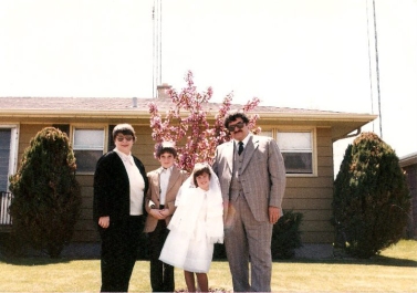 The family in front of the house for Beth's first communion - 1982
